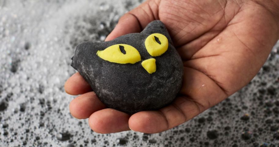 hand holding Lush Bewitched Bubble Bar