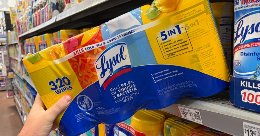 hand pulling a Lysol wipes multipack from a shelf