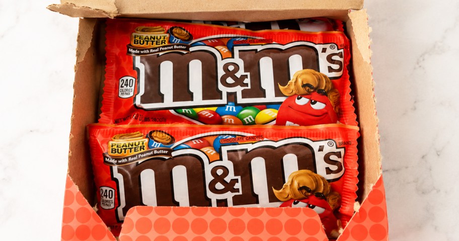 orange box full of full-size bags of M&M's Peanut Butter candies