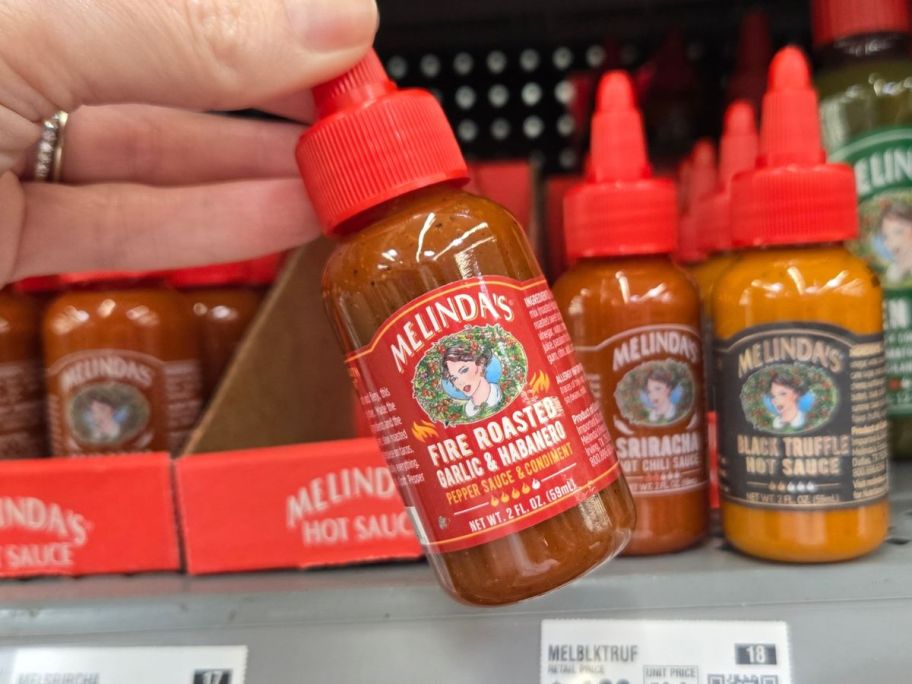 Melinda's Fire Roasted Garlic Habanero Hot Mini Sauce in hand in store