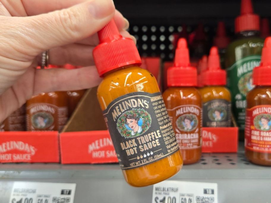 Melinda's Foods Truffle Hot Mini Sauce in hand in store