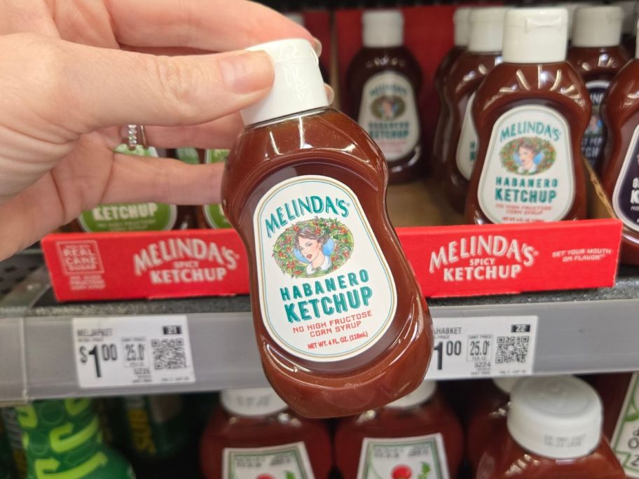 Melinda's Habanero Ketchup 4oz bottle in hand in store