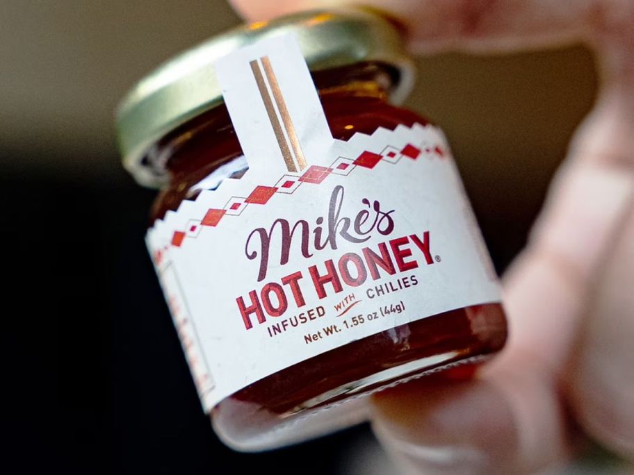 Mike's Hot Honey Infused w/ Chilies Glass Mini Jar in hand