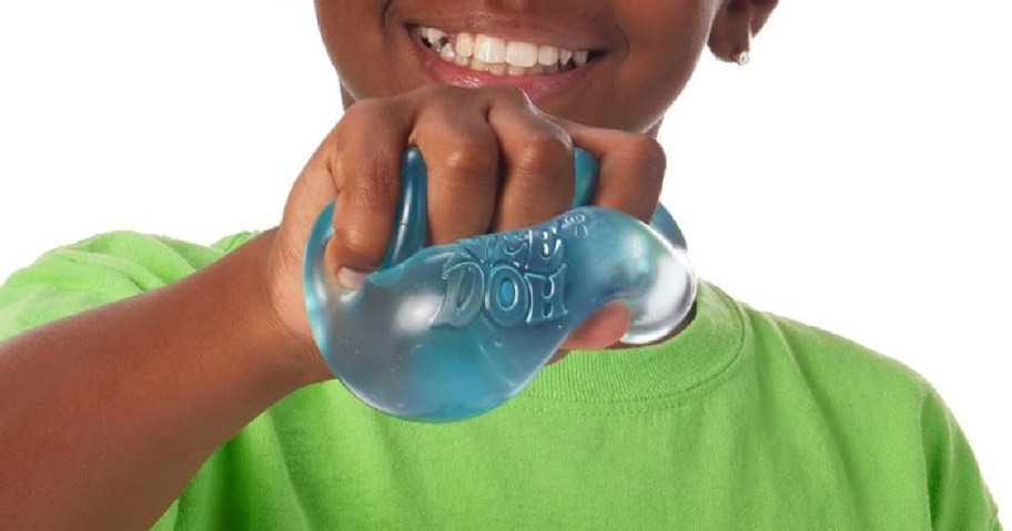 young boy holding a Needoh Nice Cube
