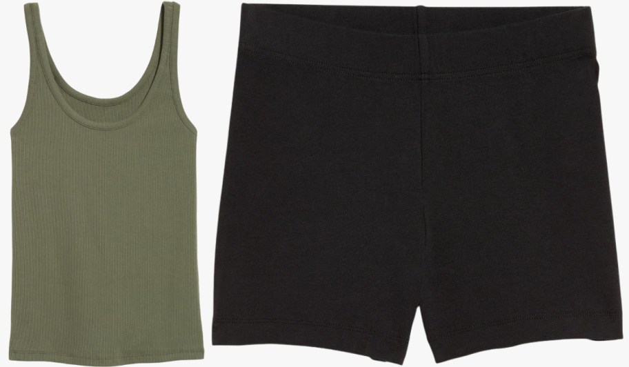 a green tank top and a pair of black bike shorts