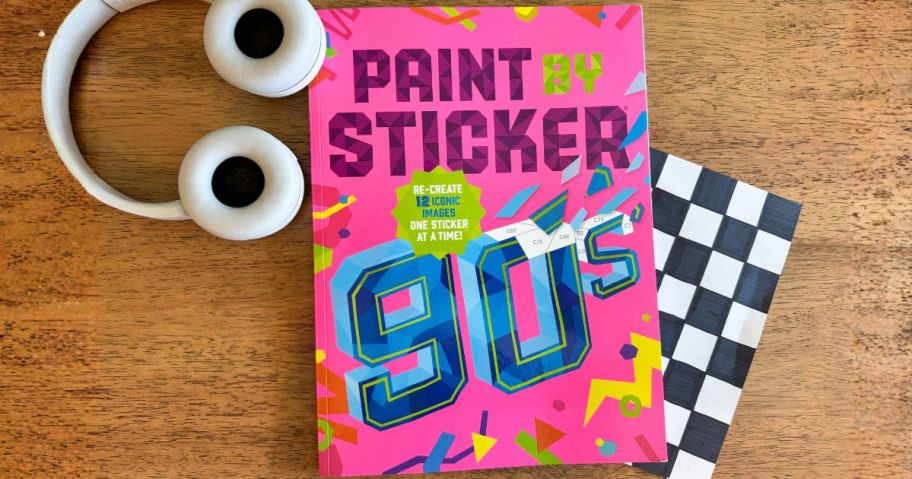Paint By Sticker '90s Edition Book on table with headphones next to it