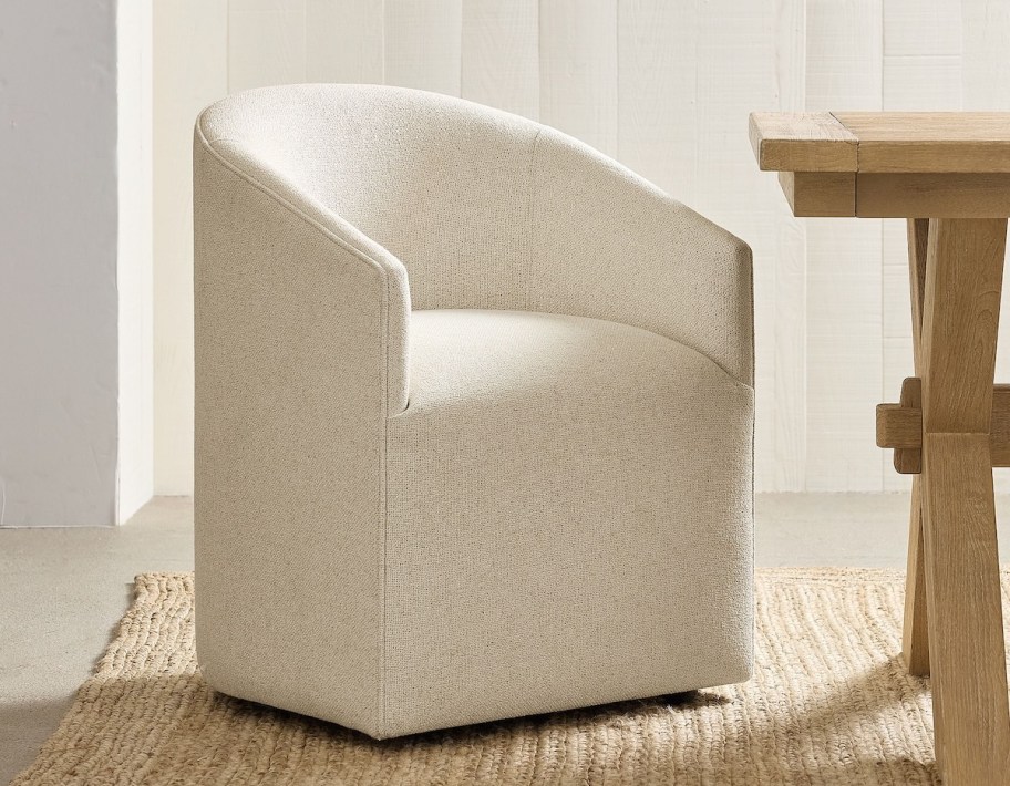 white upholstered dining chair next to wood table