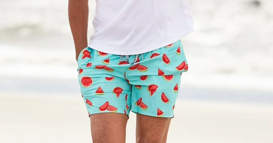 man wearing a pair of watermelon print swim trunks