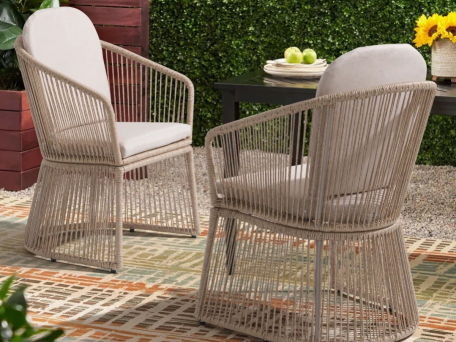 light brown wicker chairs with white cushions