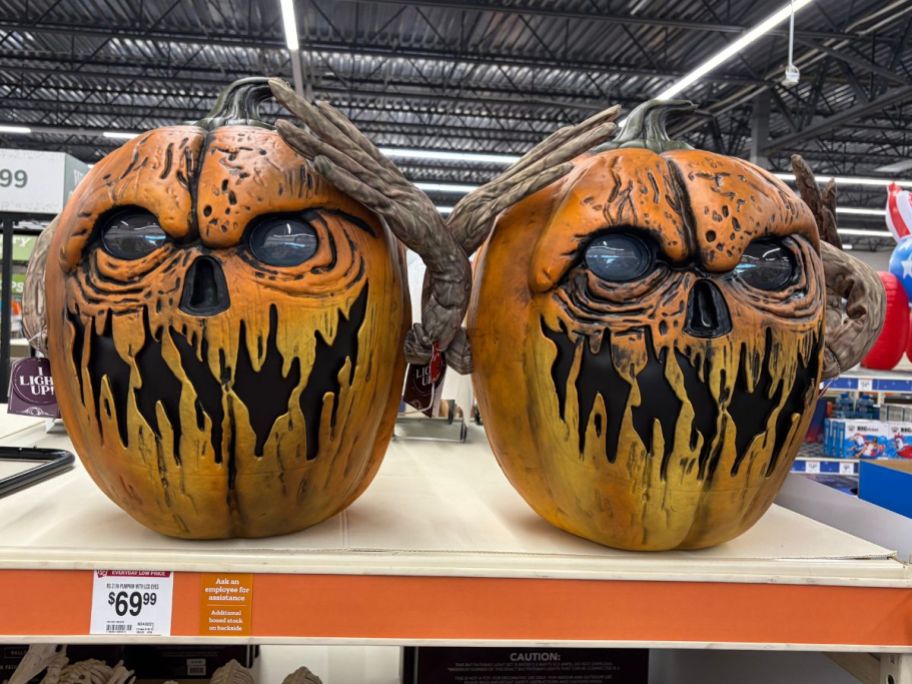 two Red Shed 21" Light-Up Halloween Pumpkin w/ Animated Eyes on shelf in store