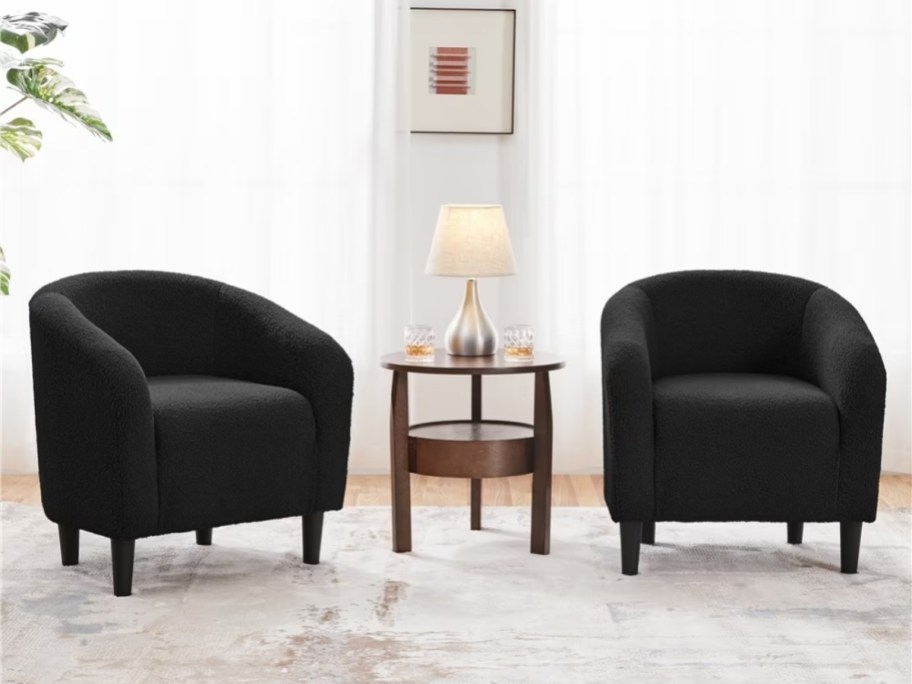 two black velvet barrel accent chairs