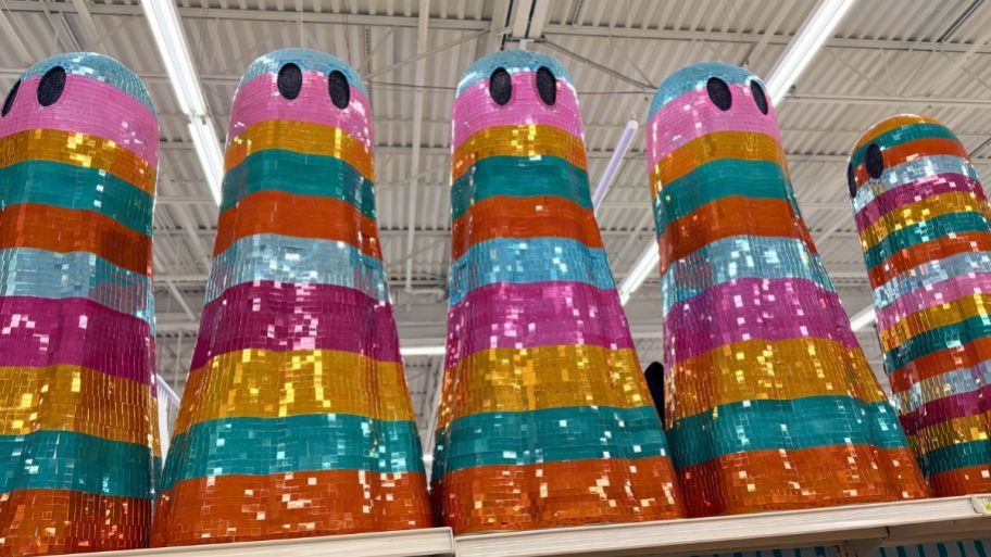 multiple Sequins ghosts displayed on top of a store display shelf