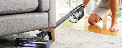 man vacuuming carpet with Shark Pet Pro Cordless Stick Vacuum
