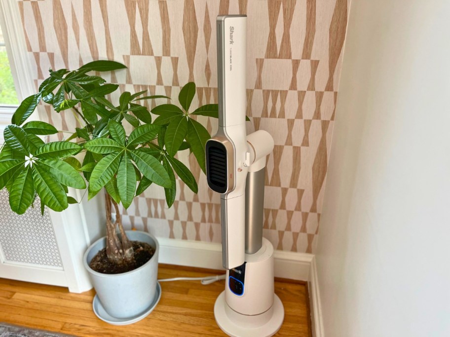 a Shark fan and heater in a living room next to a plant