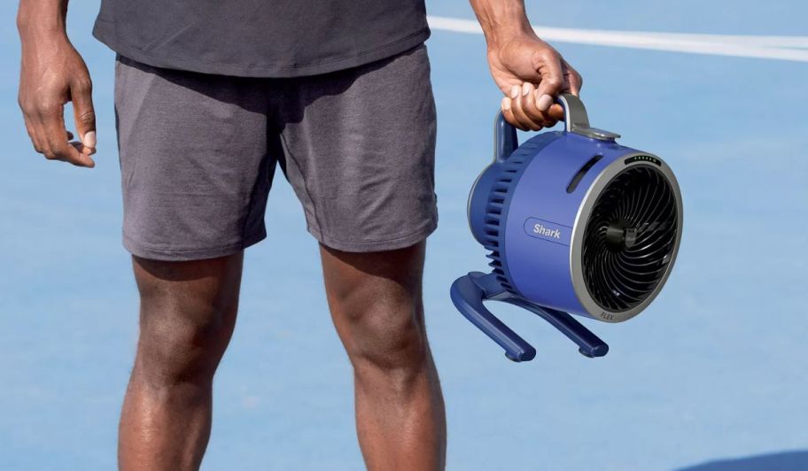 man holding QVC Shark mist fan blue