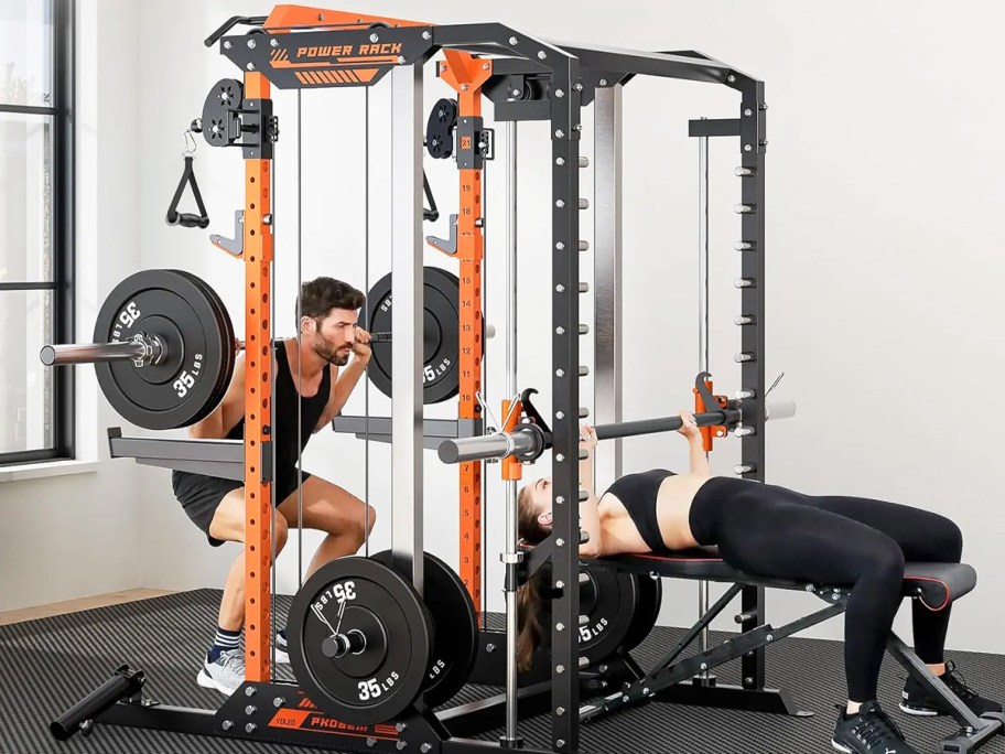 man and woman working out on a home gym system