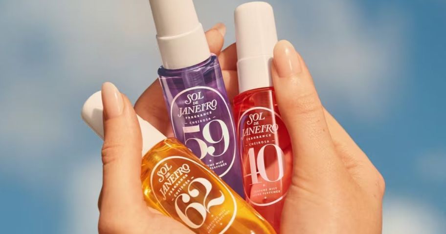 Hands holding Sol de Janeiro 1oz Perfume Mists