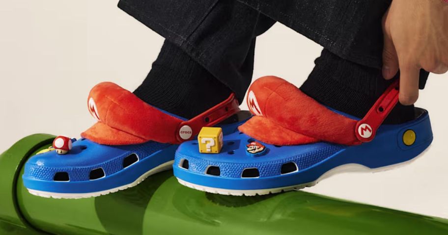 Feet wearing Super Mario Crocs