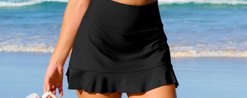 Woman wearing a black swim skirt on a beach