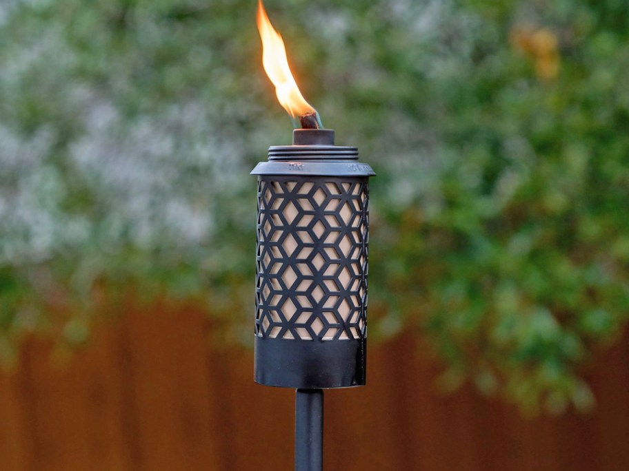black metal tiki torch with a flame