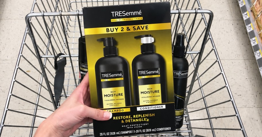 hand holding up a boxed TRESemmé Shampoo & Conditioner set in store