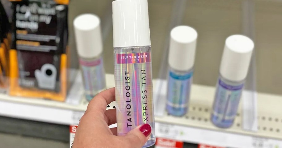 hand holding a Tanologist bottle