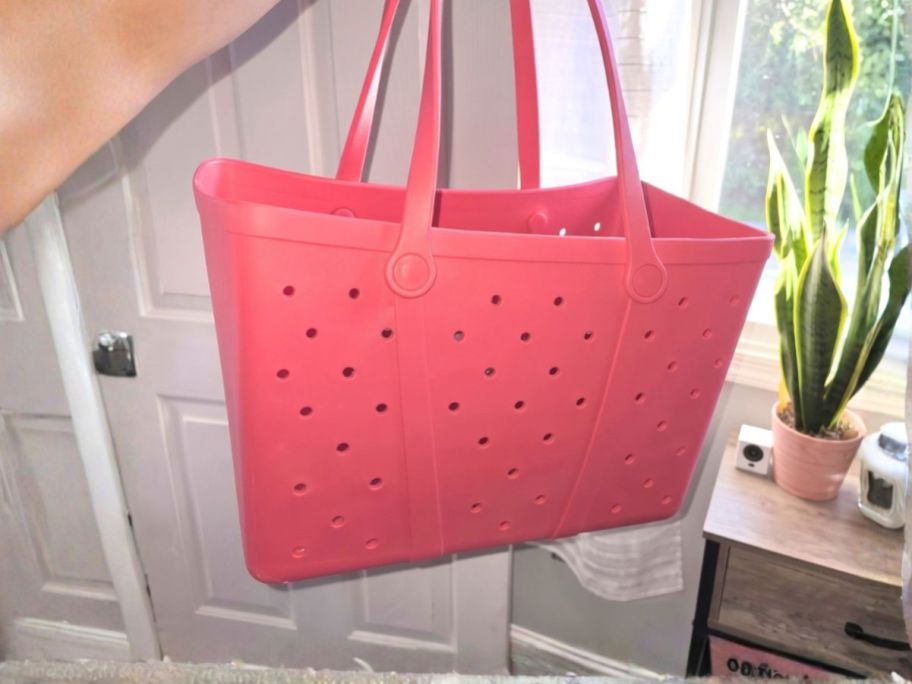 person holding pink Time and Tru Women's Waterproof EVA Beach Tote Bag