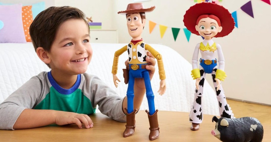 little boy playing with woody and jessie toy story 5 interactables toys on table