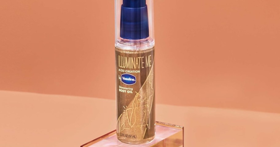 bottle of vaseline illuminate me shimmering body oil with terracotta background