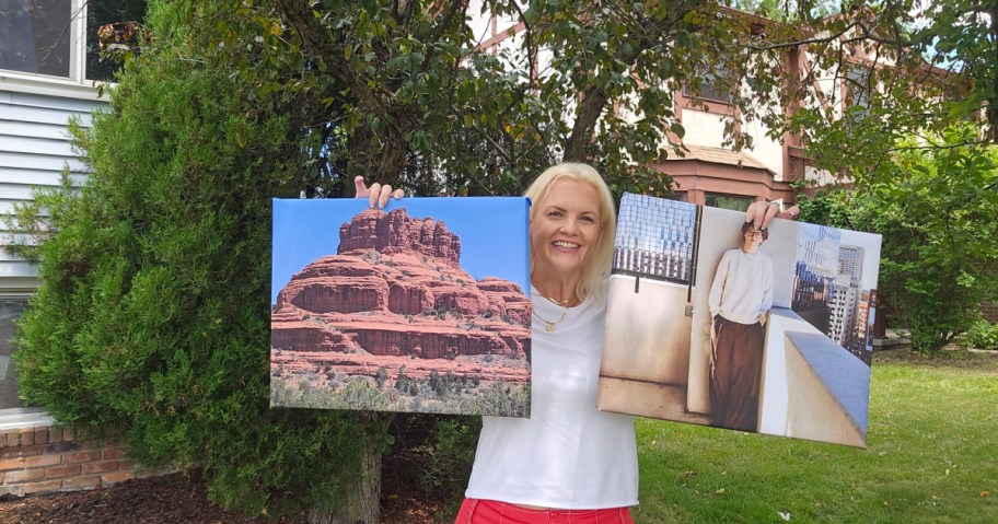 woman holding up 2 Walgreens photo canvases featuring a young man and a mountain