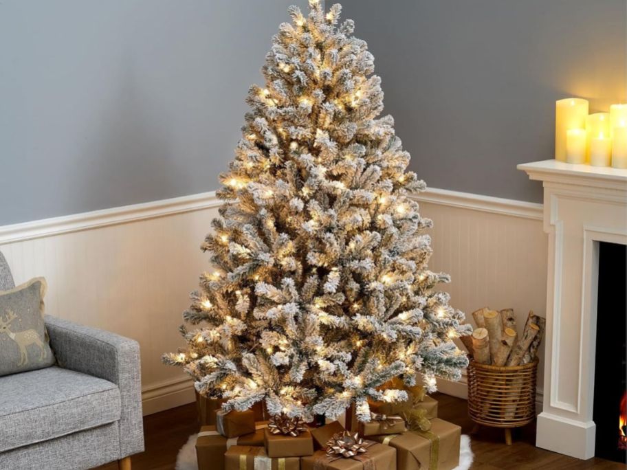 A flocked Christmas tree in a living room