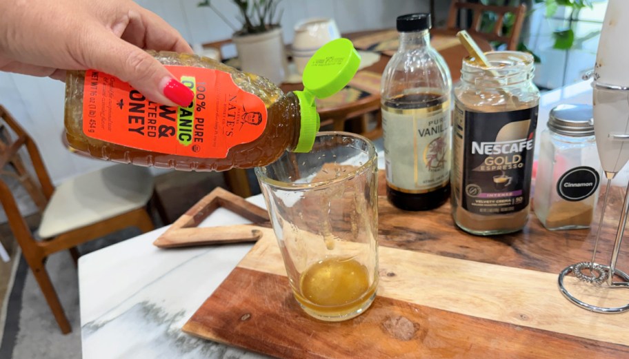 adding honey to a cup