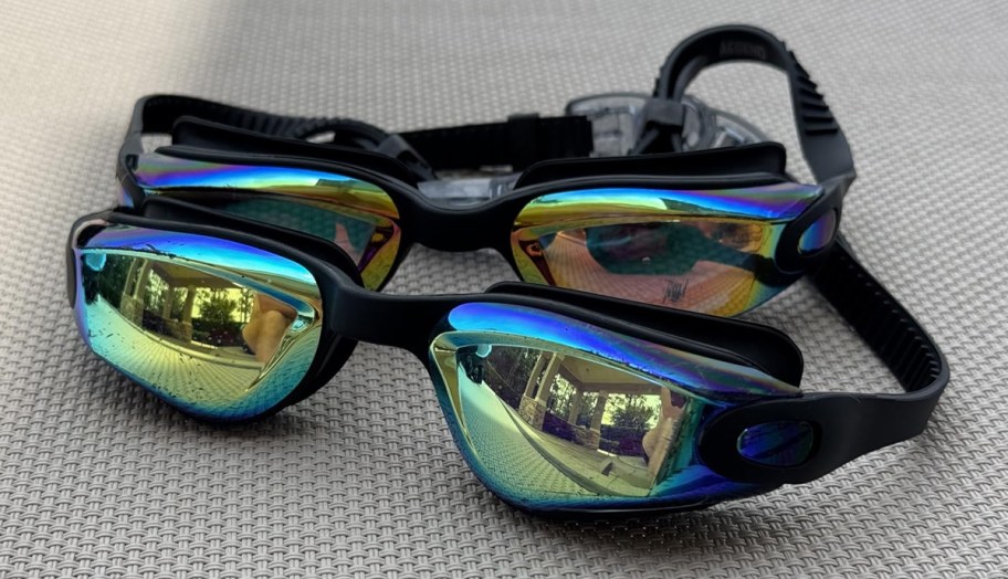 two pairs of black goggles on table