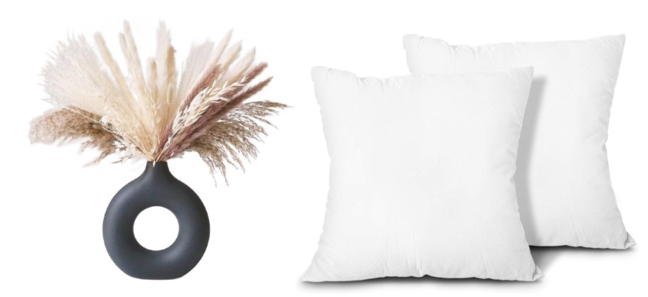 black round vase next to two white pillows