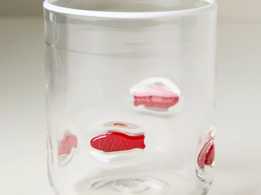 glass with red fish 