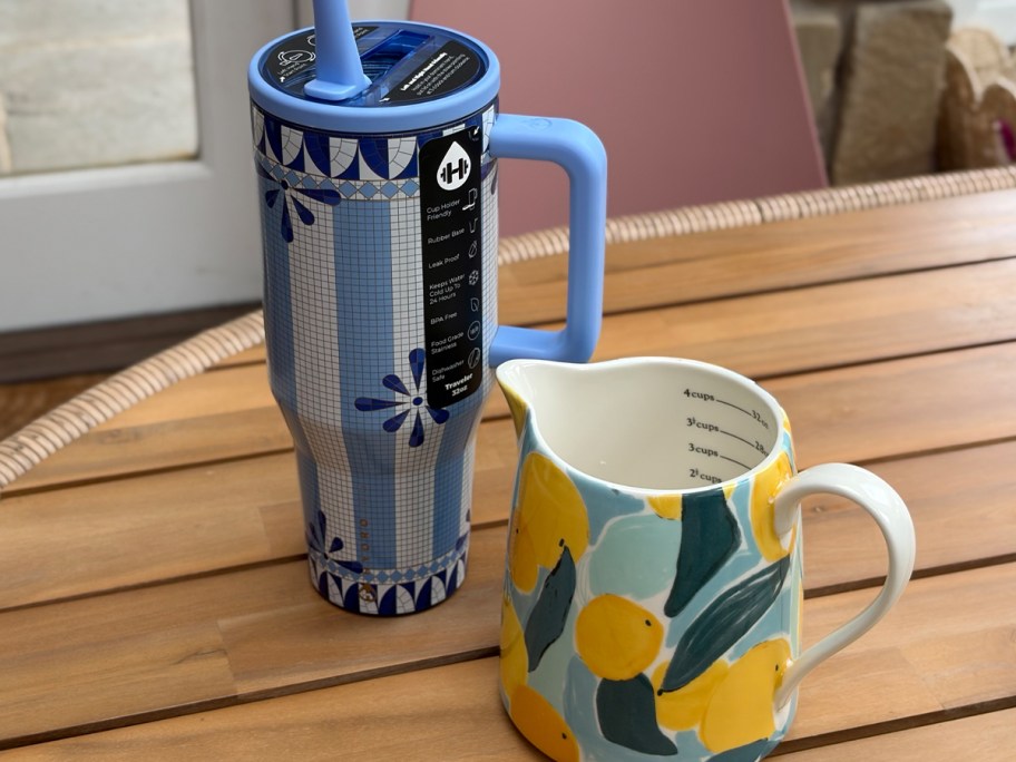 blue tumbler and lemon measuring cup on table