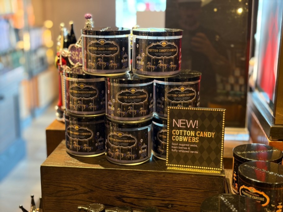 bath and body works 3 wick halloween candles stacked on a table in a store