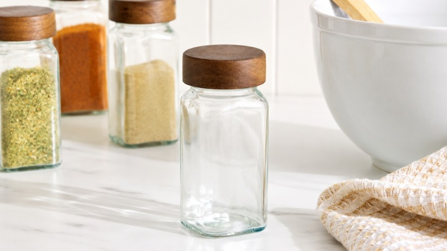 glass spice jars on a kitchen countertop