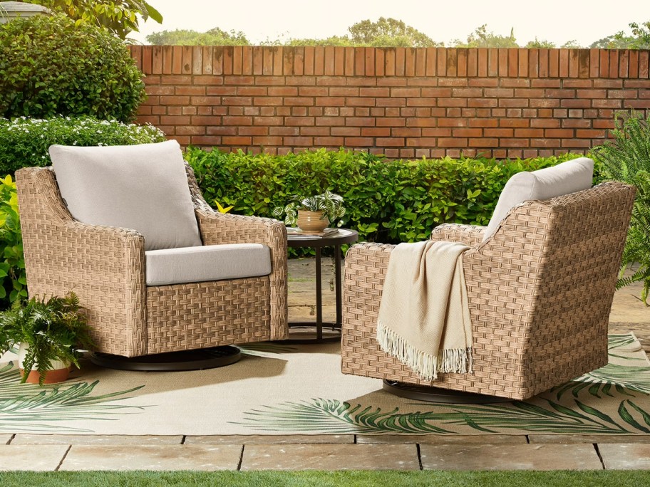 two wicker chairs with beige cushions outdoors 