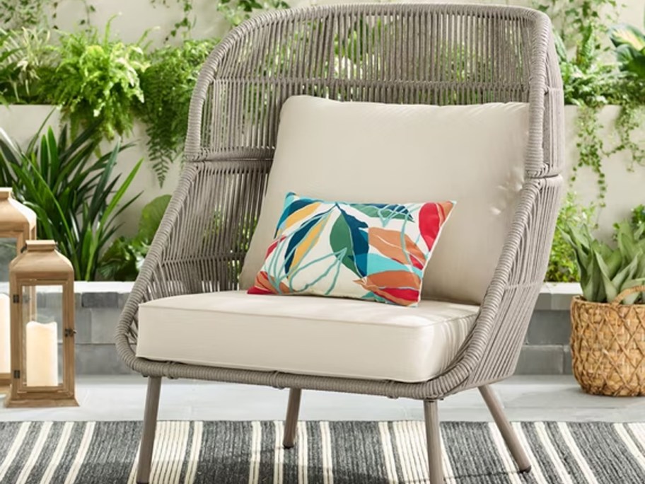 gray wicker accent chair with beige cushions 