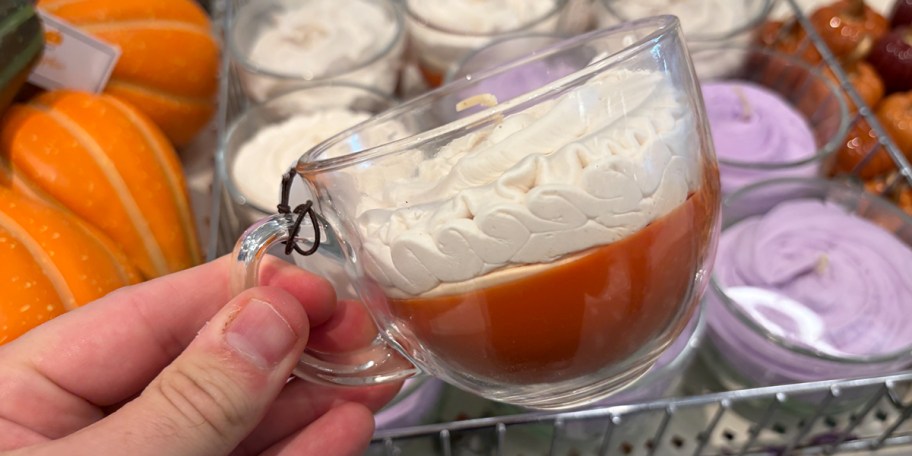 hand holding mug candle 