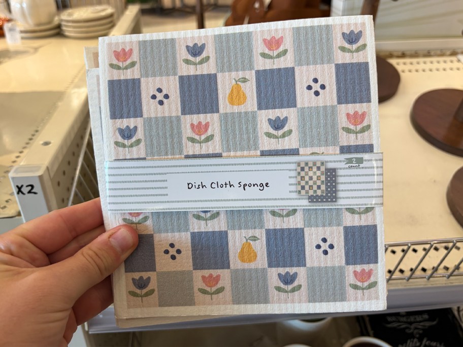 hand holding floral dish sponge rags 