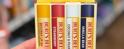 A 4-pack box of Burt's Bees lip balms featuring Beeswax, Strawberry, Coconut & Pear, and Vanilla Bean flavors.