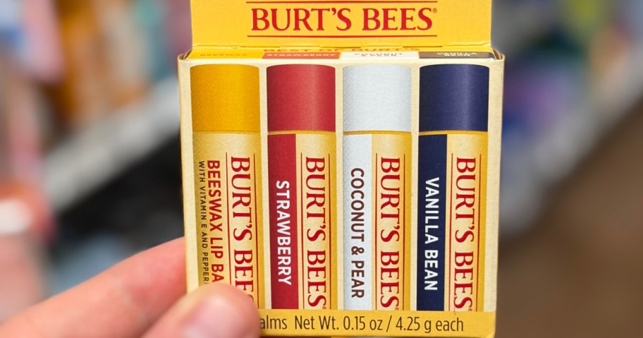 A 4-pack box of Burt's Bees lip balms featuring Beeswax, Strawberry, Coconut & Pear, and Vanilla Bean flavors.