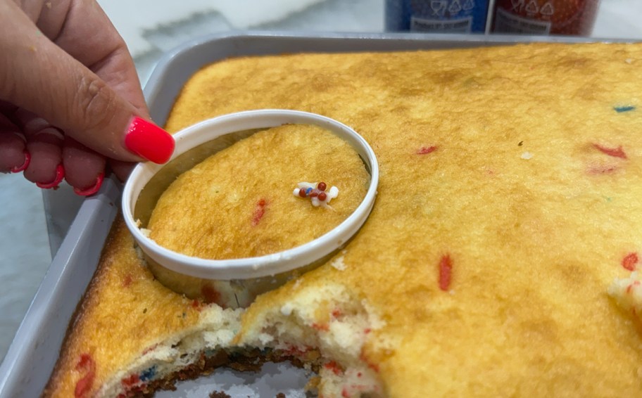 person using cake cutter on cake