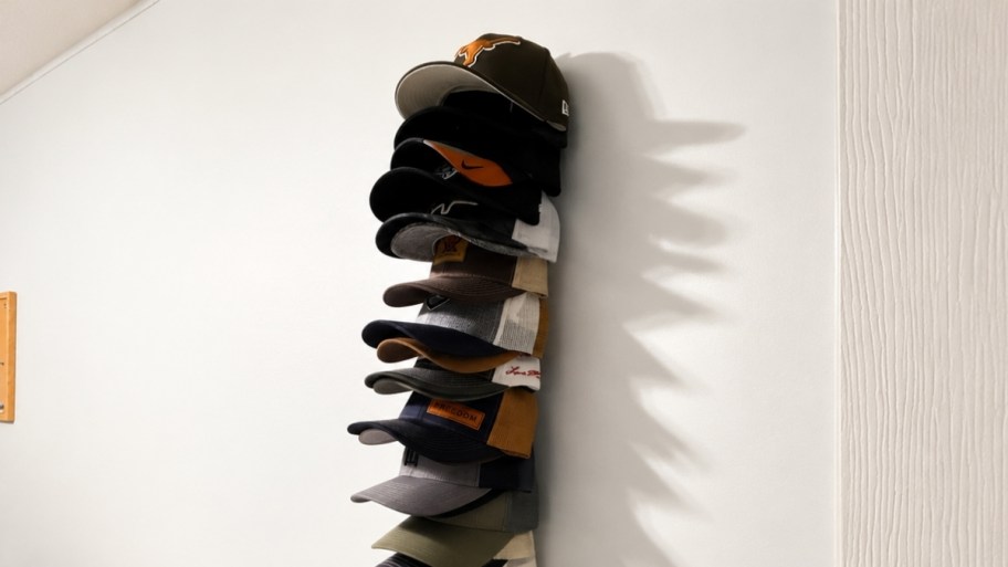 cap organizer on a wall with caps
