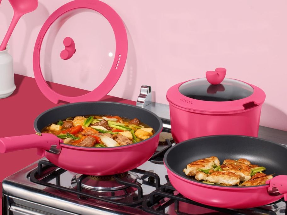 pink cookware on a black stovetop