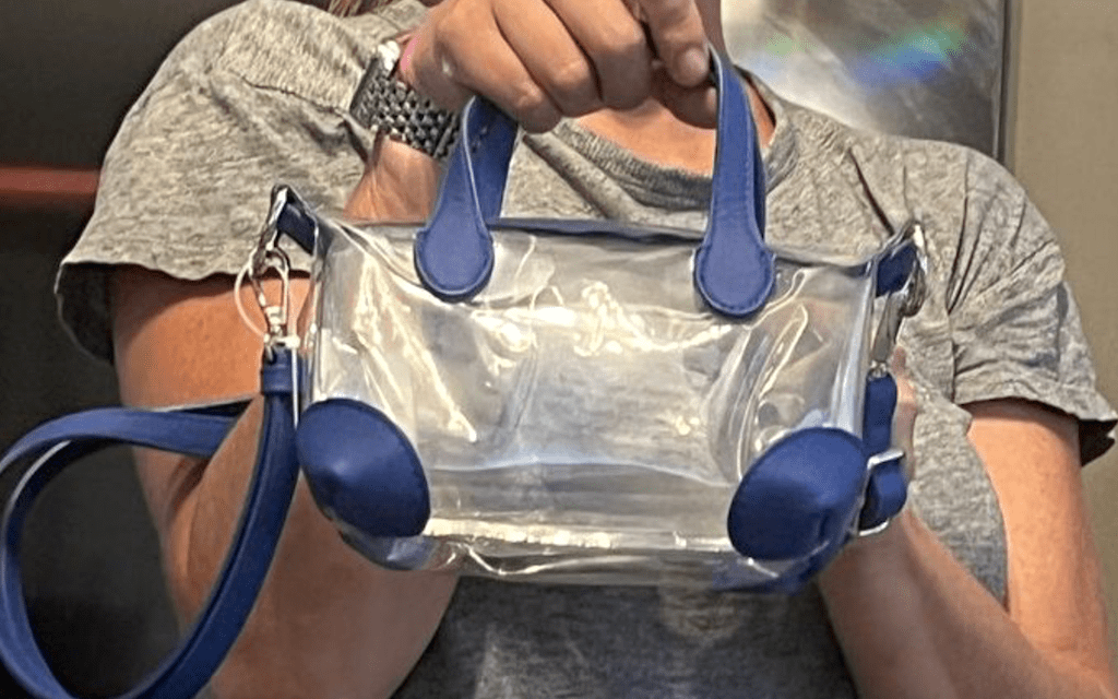 holding clear crossbody bag 