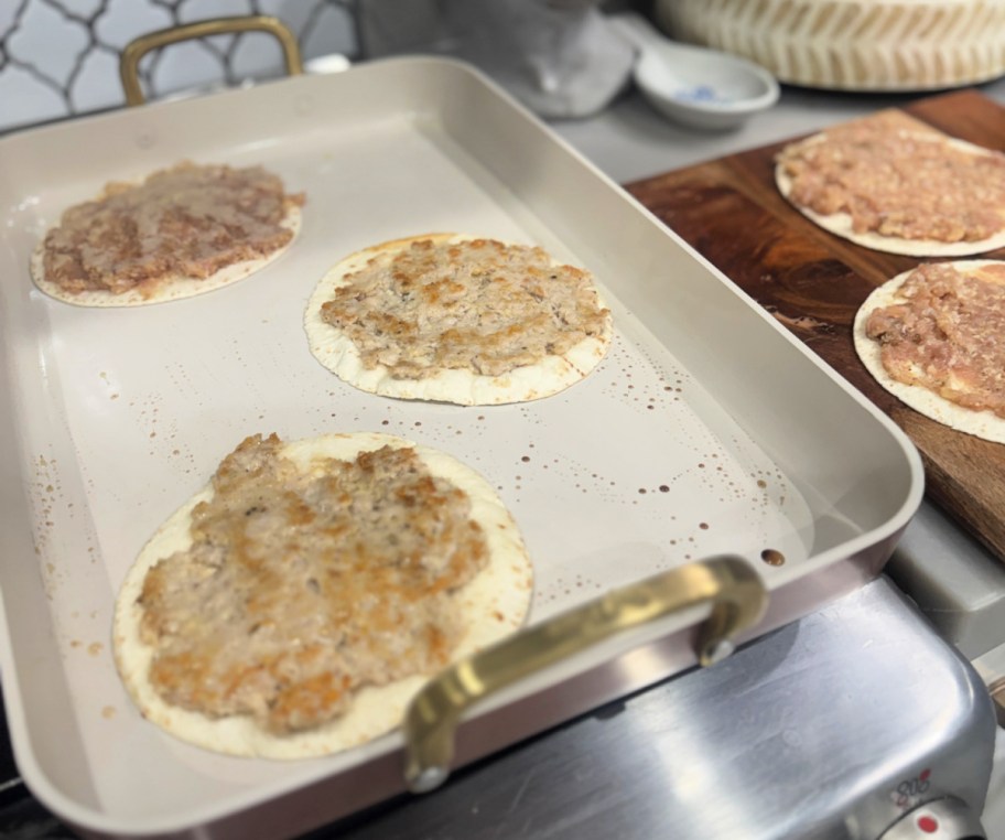 cooking smashed tacos on a griddle pan