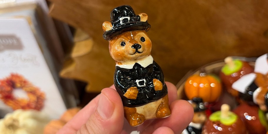 hand holding pilgrim salt shaker 